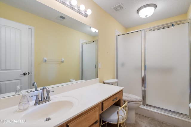 bathroom with vanity, a textured ceiling, toilet, and an enclosed shower