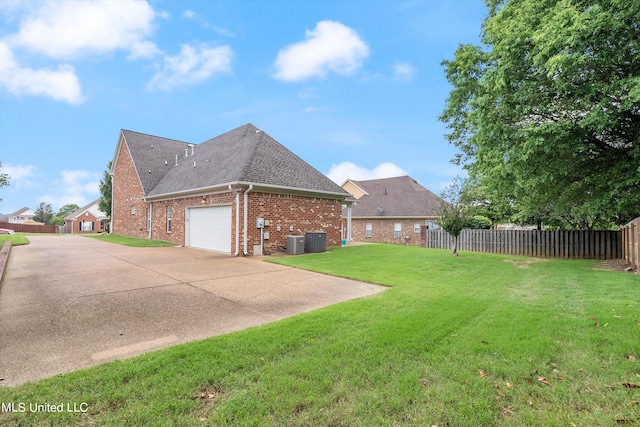 view of property exterior with a garage, a lawn, and central AC unit