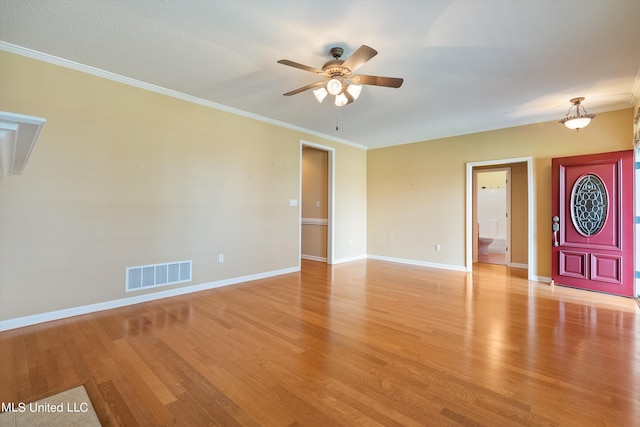 interior space featuring ornamental molding and light wood-type flooring