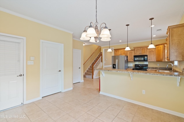 kitchen featuring pendant lighting, crown molding, black appliances, and kitchen peninsula