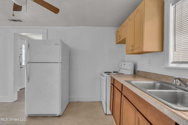 kitchen featuring white appliances, visible vents, a wealth of natural light, and a sink