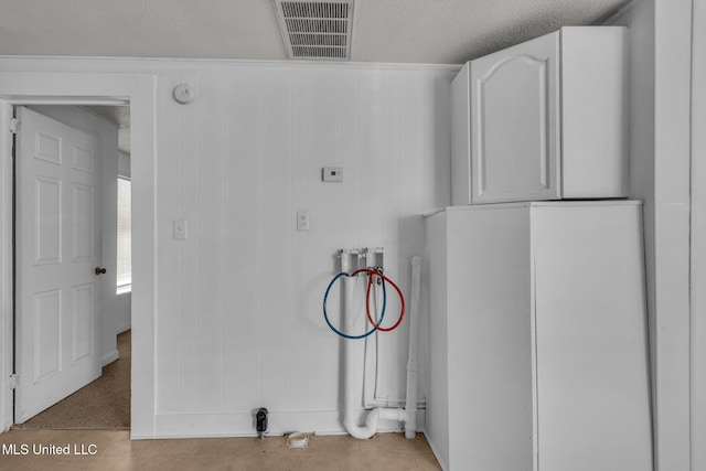 clothes washing area with laundry area, visible vents, and washer hookup