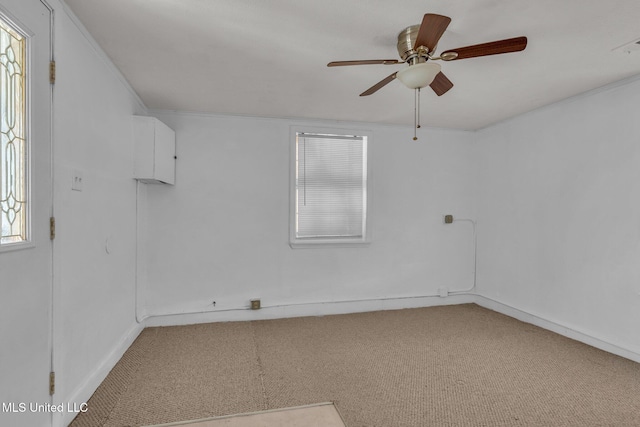 carpeted spare room with ceiling fan