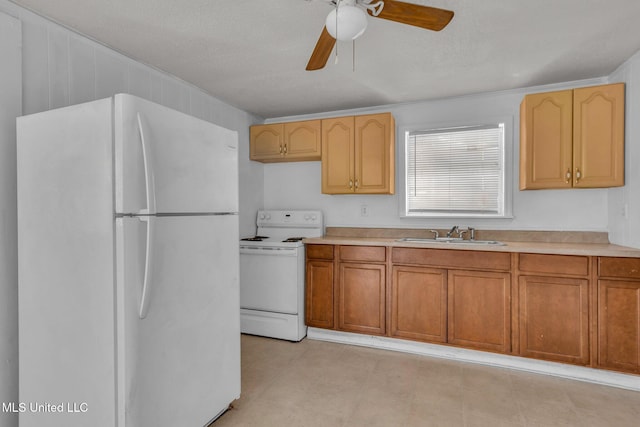 kitchen with white appliances, a ceiling fan, light countertops, light floors, and a sink