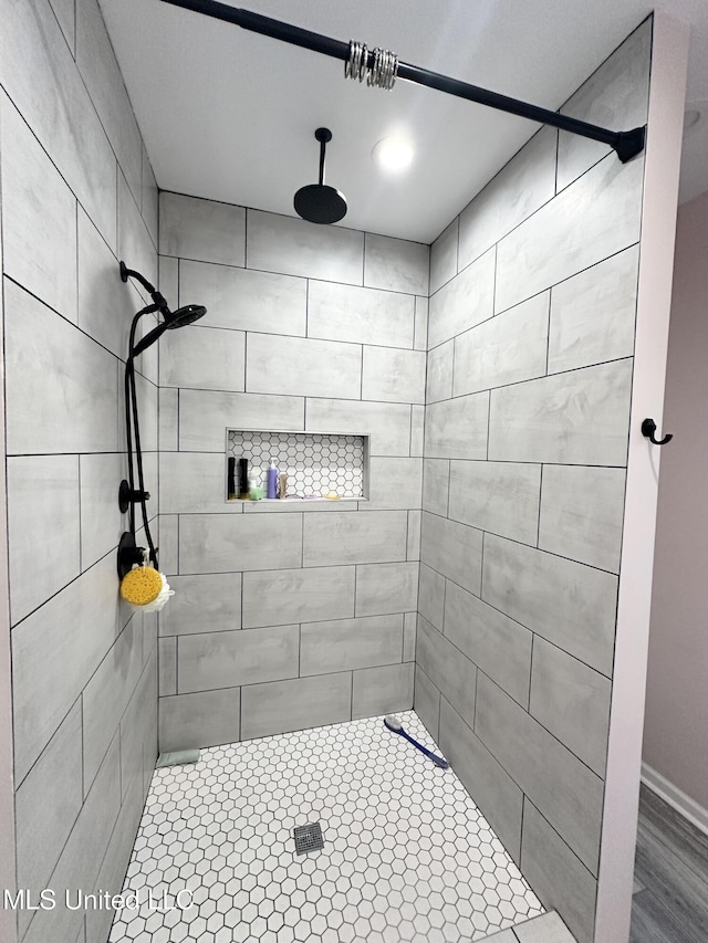 full bathroom with a tile shower