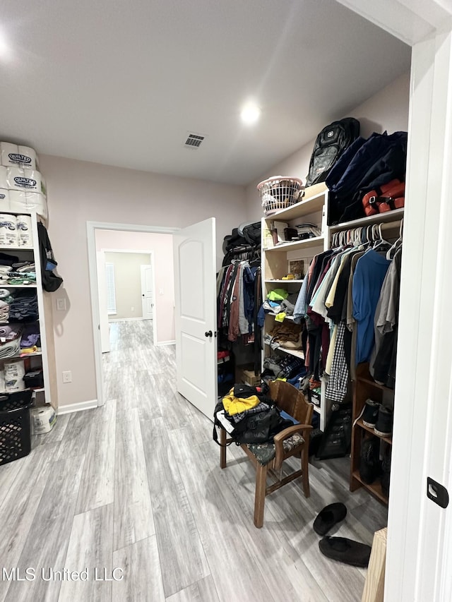 walk in closet featuring visible vents and wood finished floors