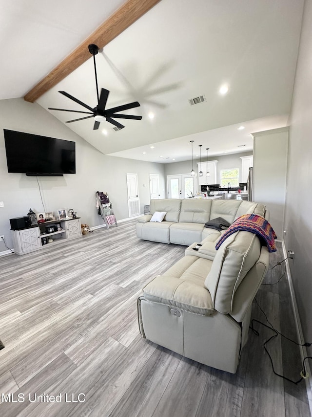 living area with recessed lighting, visible vents, ceiling fan, vaulted ceiling with beams, and wood finished floors