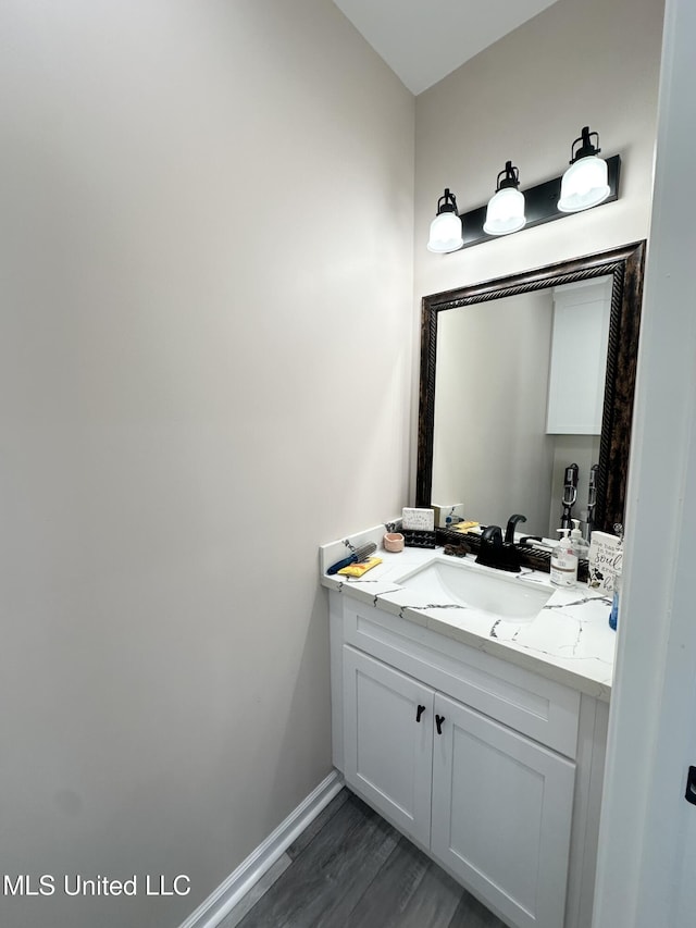 bathroom with vanity and baseboards