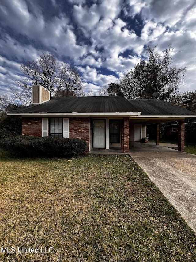 4263 Cypress Dr, Jackson, MS 39212 - ranch-style house with a carport, a chimney, concrete driveway, a front yard, and brick siding