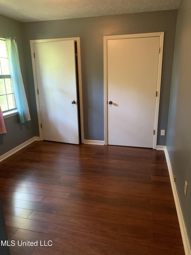 4263 Cypress Dr, Jackson, MS 39212 - unfurnished bedroom featuring wood finished floors and baseboards