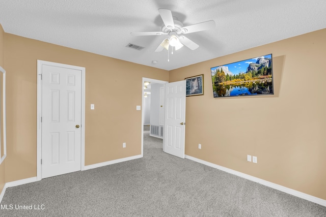 unfurnished bedroom featuring visible vents, baseboards, carpet, and a textured ceiling