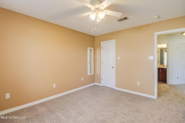 unfurnished bedroom with visible vents, baseboards, light colored carpet, and a ceiling fan