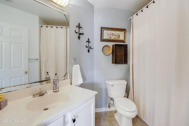 bathroom with vanity, tile patterned floors, toilet, and baseboards