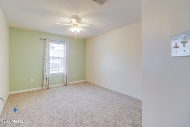 spare room with baseboards, carpet, and ceiling fan