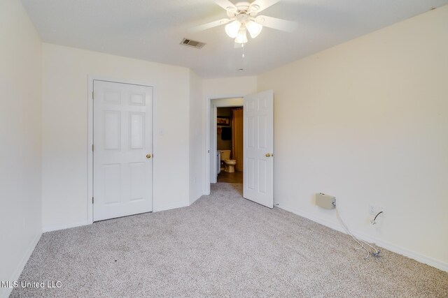 unfurnished bedroom featuring visible vents, ceiling fan, baseboards, and carpet