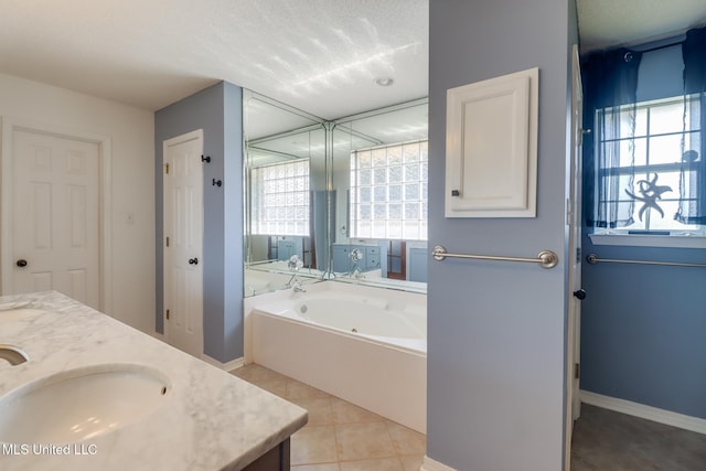 bathroom featuring vanity, a garden tub, baseboards, and tile patterned floors