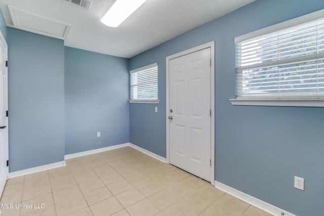 31 55th St, Gulfport, MS 39507 - foyer with a textured ceiling and light tile patterned flooring