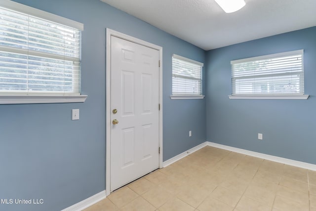 31 55th St, Gulfport, MS 39507 - foyer entrance with baseboards and light tile patterned floors