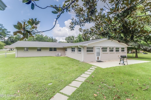 31 55th St, Gulfport, MS 39507 - back of property featuring brick siding, a patio, and a yard