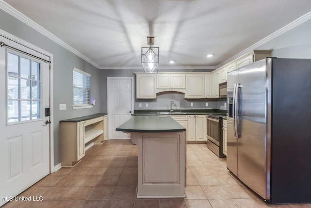 31 55th St, Gulfport, MS 39507 - kitchen with stainless steel appliances, dark countertops, light tile patterned floors, crown molding, and a center island