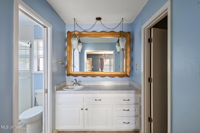 bathroom with vanity, a textured ceiling, and toilet