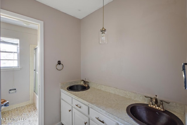 bathroom featuring vanity, shower / bath combination with glass door, and tile patterned flooring