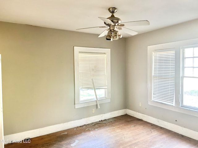 spare room featuring hardwood / wood-style floors and ceiling fan