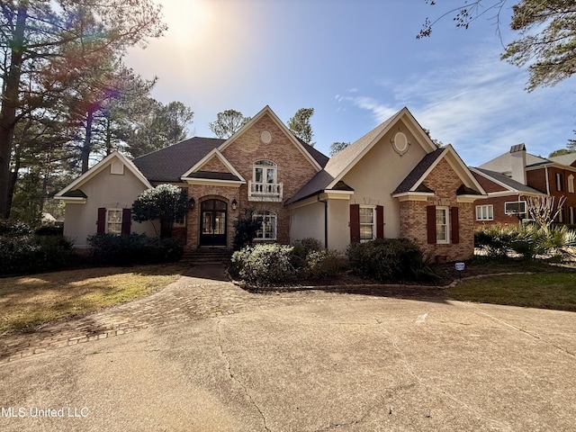 view of front of home with brick siding and stucco siding