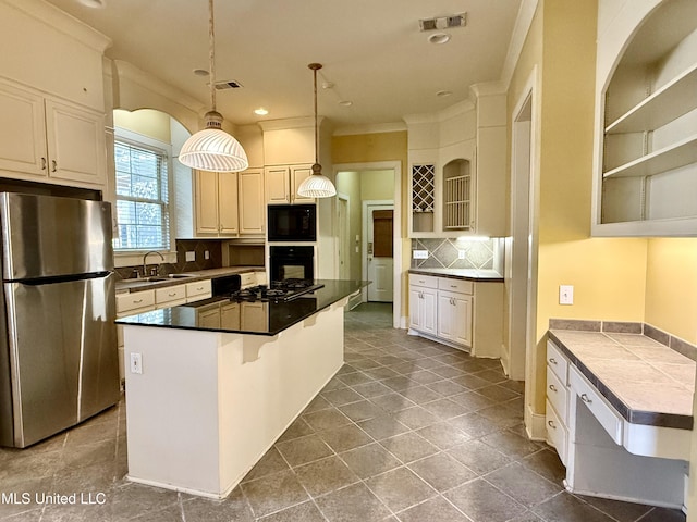 kitchen featuring black appliances, visible vents, backsplash, and a sink