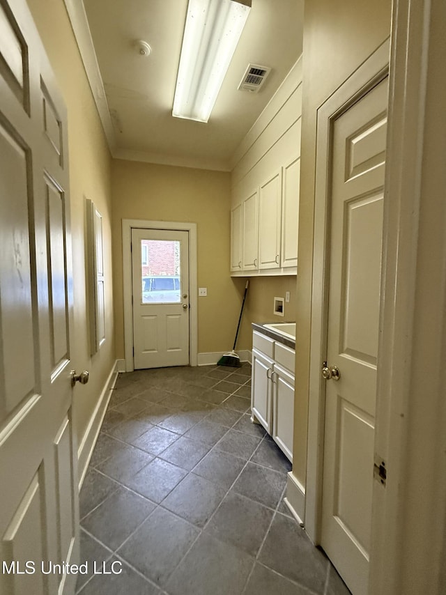 laundry room with hookup for a washing machine, cabinet space, visible vents, ornamental molding, and baseboards