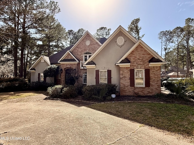 view of front of property with brick siding and stucco siding