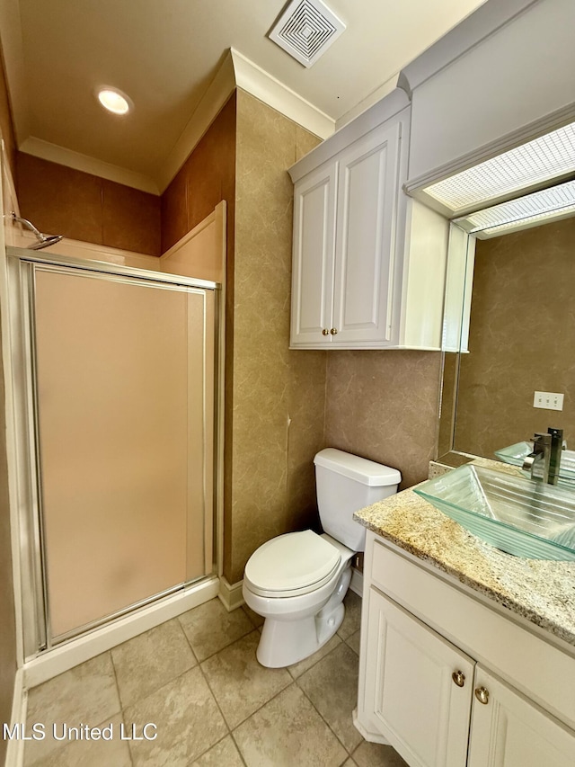 bathroom featuring visible vents, toilet, a shower stall, vanity, and tile patterned flooring