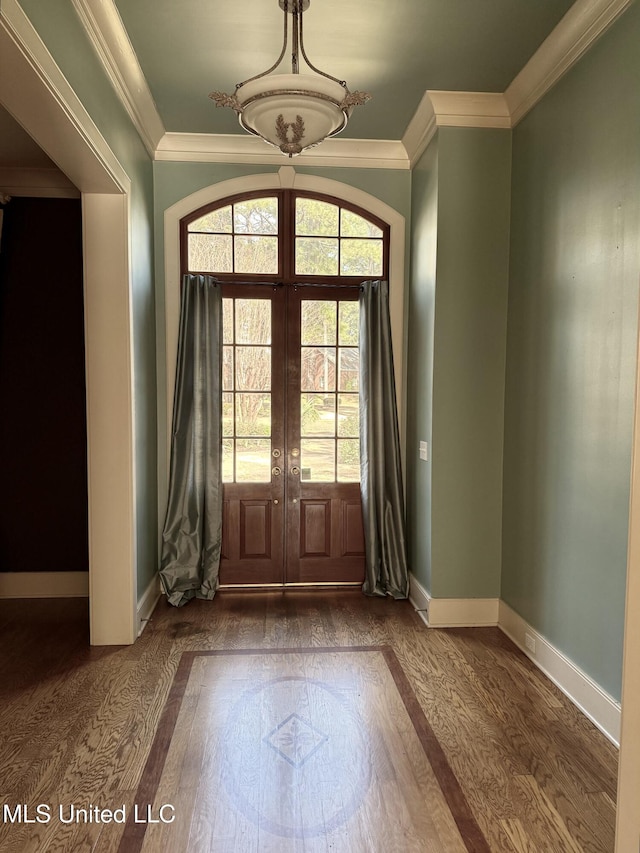 entryway featuring baseboards, ornamental molding, dark wood-type flooring, and french doors