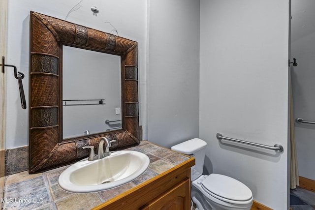 bathroom with toilet and vanity