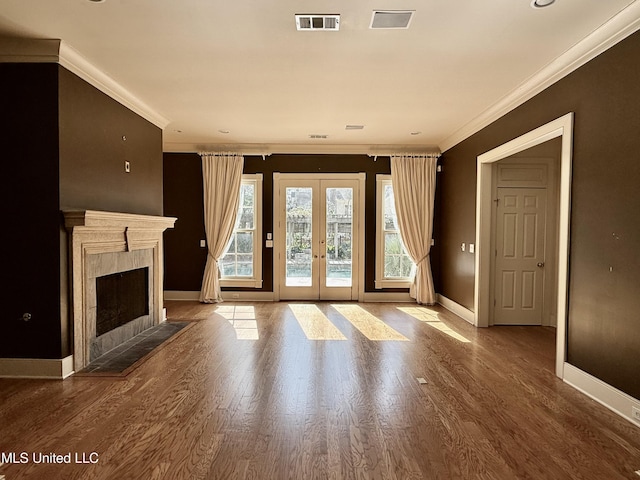 unfurnished living room with ornamental molding, french doors, wood finished floors, and visible vents