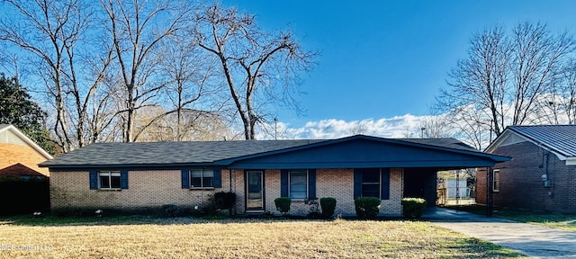 ranch-style home with a front lawn and a carport