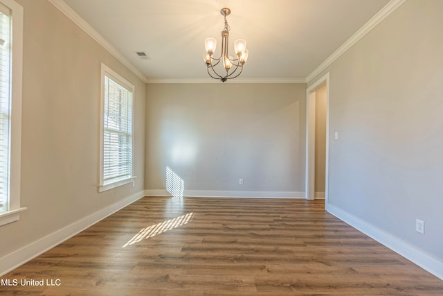 unfurnished room with ornamental molding, a chandelier, and dark wood-type flooring