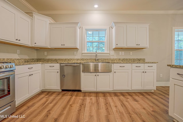 kitchen with a wealth of natural light, sink, and light hardwood / wood-style flooring