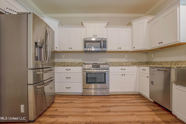 kitchen with crown molding, appliances with stainless steel finishes, light hardwood / wood-style flooring, and white cabinets