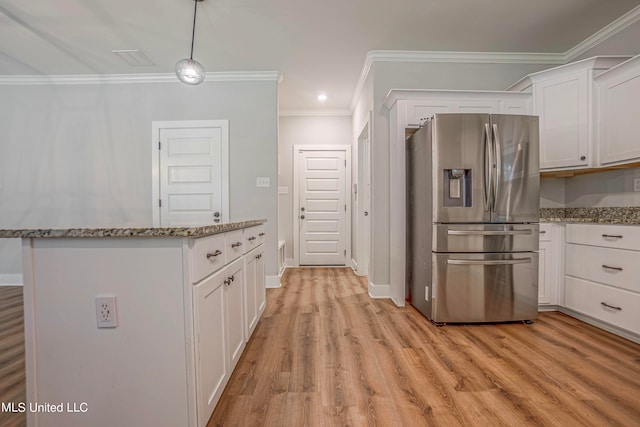 kitchen featuring light stone countertops, stainless steel fridge, white cabinets, and light wood-type flooring