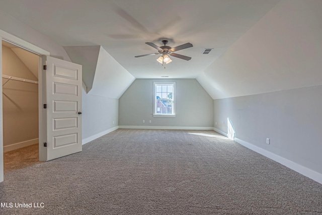 bonus room featuring lofted ceiling, carpet floors, and ceiling fan