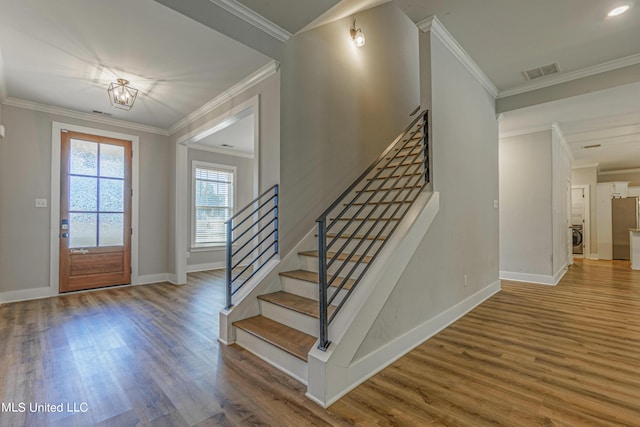 5640 Drew Glazer Dr, Olive Branch, MS 38654 - foyer with wood finished floors, stairway, baseboards, ornamental molding, and washer / dryer