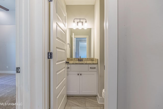 5640 Drew Glazer Dr, Olive Branch, MS 38654 - bathroom featuring vanity, baseboards, and toilet