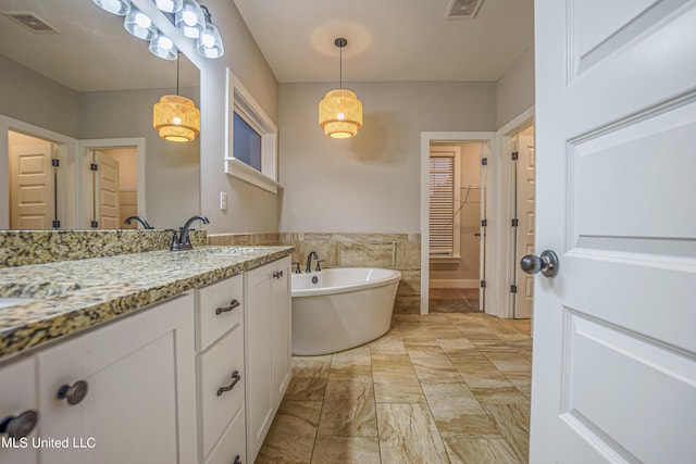 5640 Drew Glazer Dr, Olive Branch, MS 38654 - bathroom featuring vanity, a freestanding tub, marble look tile flooring, a closet, and tile walls