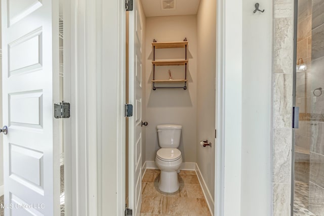 5640 Drew Glazer Dr, Olive Branch, MS 38654 - bathroom with toilet, tiled shower, and baseboards