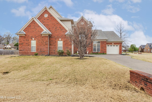 traditional-style home featuring a garage, brick siding, and driveway