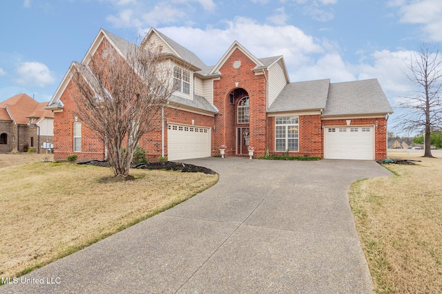 traditional-style house featuring asphalt driveway, brick siding, a front yard, and a shingled roof