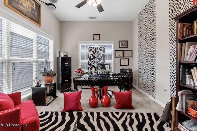 office with a ceiling fan, baseboards, and carpet flooring