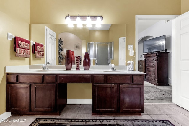 full bathroom featuring tile patterned flooring, a shower stall, and double vanity