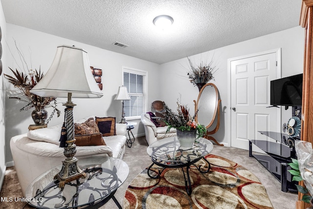 living area with a textured ceiling and light colored carpet
